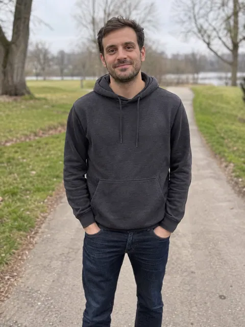 The owner’s photo: a smiling man in a dark hoodie on a park path